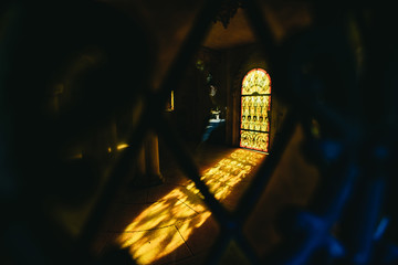 Warm golden light shining through an arched window