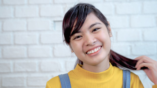 Close up of cute Southeast Asian teenagers are smiling bright and cute - Powered by Adobe