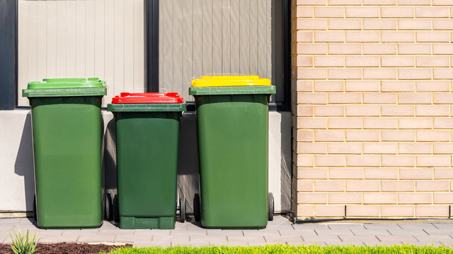 Australian home wheelie bins set on front yard