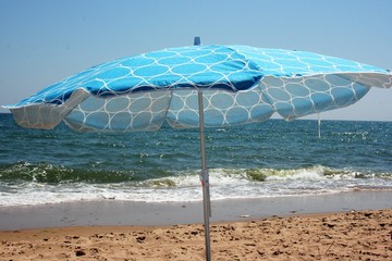 beach with golden sun and umbrella