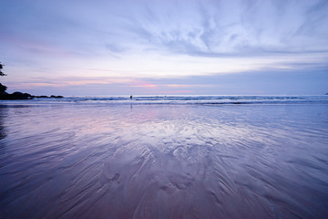 Sea and sunset. Beautiful seascape with purple sky and water reflection..