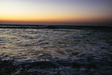 Person surfing at sunset at Sidi Kaouki