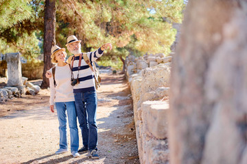 Travel and tourism. Senior family couple walking together on ancient sighseeing.