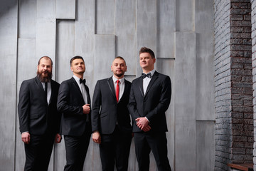Group of handsome elegant young men in toxedo.