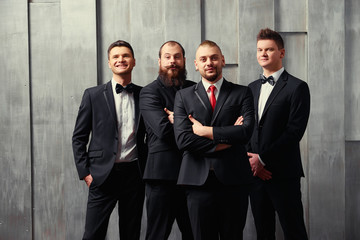 Group of handsome elegant young men in toxedo.