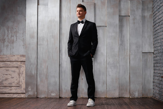 Elegance and style. Portrait of handsome young man wearing tuxedo and tie.