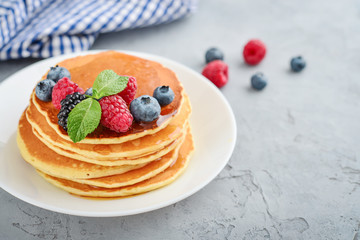 Pancakes with fresh berries and maple syrup