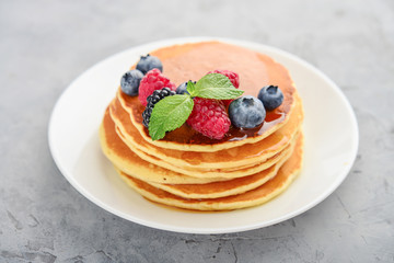 Pancakes with fresh berries and maple syrup