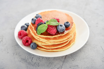Pancakes with fresh berries and maple syrup