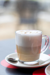 Latte coffee with croissant, breakfast in the cafeteria