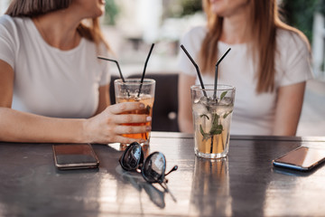 leisure, holidays, eating, people and food concept - happy friends having dinner at summer garden party and clinking drinks