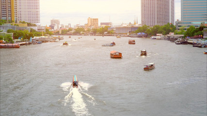 Boat traffic in the Chao Phraya River in the city center, Bangkok city view of chao phraya river major river in Thailand.