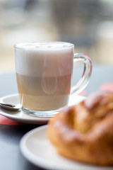 Latte coffee with croissant, breakfast in the cafeteria