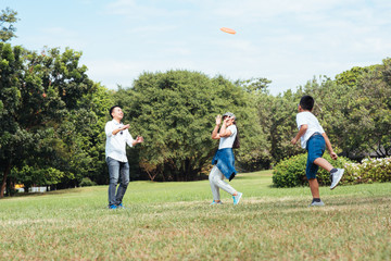 Happy children and parents playing in the park. Concept family relaxation.