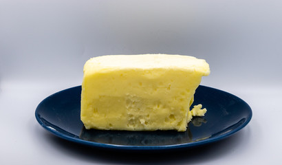 Butter on a blue plate against colourful back drop. Calgary, Alberta, Canada