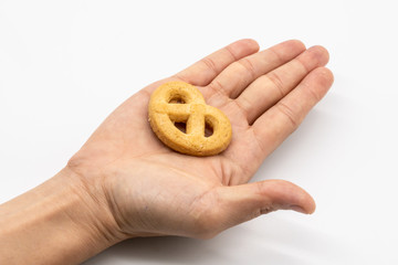 Hand holding the homemade cookie isolated on white