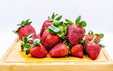 Strawberries on a wooden cutting board. Calgary, Alberta, Canada