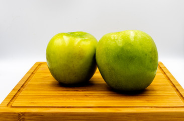 Green apples on a wooden cutting board. Calgary, Alberta, Canada