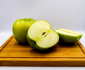 Green apples on a wooden cutting board. Calgary, Alberta, Canada
