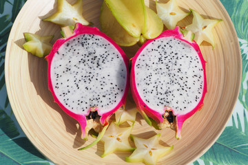 Dragon fruit and carambola cut on the table top view.