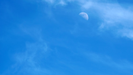 moon on a blue sky day