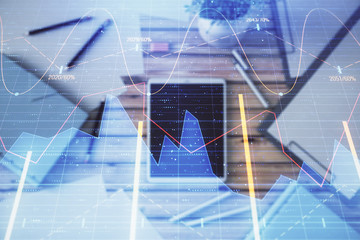 Double exposure of forex graph on digital tablet laying on table background. Concept of market analysis