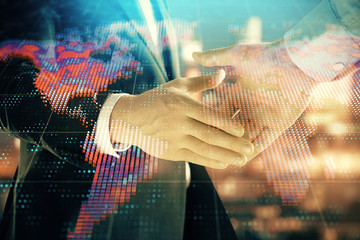 Double exposure of world map on cityscape background with two businessmen handshake. Concept of international business