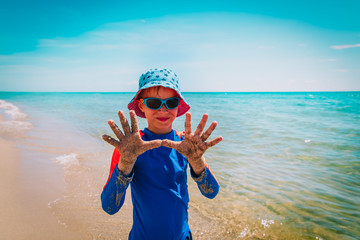 happy cute boy having fun on tropical beach