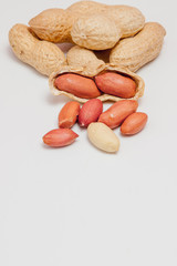 Large peeled peanuts close-up of beans in the shell. Unpeeled peanuts in the shell. Peanuts, for...
