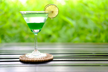 glass of martini with olives on a background