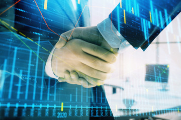 Multi exposure of financial graph on office background with two businessmen handshake. Concept of success in business