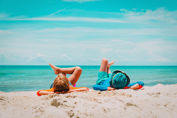 Fototapeta na wymiar little boy and girl relax on tropical beach