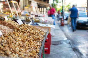 Walnuts inside a metal table for sale at an outdoor market.Nice soft background.