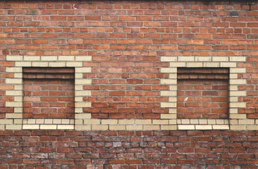 Fototapeta premium Red brick stone wall with yellow bricks to create tower shapes