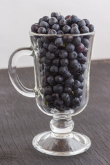 Fresh forest blueberries in a glass