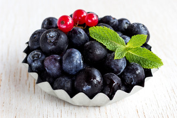 Healthy food concept: frozen blueberries on white background