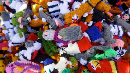 Fototapeta na wymiar Many small self-made colorful finger puppets for sale at a flea market 