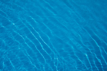 blue water background. turquoise marine texture.Sunny highlights in the water.