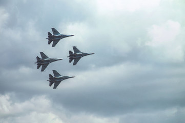 Group of four military aircraft of fighters, jet airplane in the sky make maneuvers