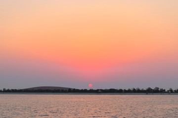 Naklejka premium SUNSET VIEW FROM SEA SHORE - BEACH BANK