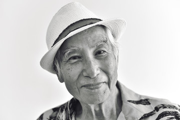 Cheerful asian senior old man, Confident and smiling elderly people with sunglasses in colorful hawaii shirt, Happy retiree citizen and travel concept, Black and white processed.