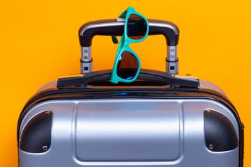 Summer sunglasses on suitcase. Travel and vacation concept