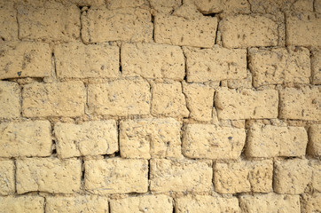 old yellow mud brick wall background