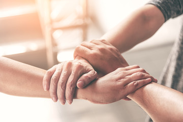 Fototapeta premium People hand assemble as a connection meeting teamwork concept. Group of people assembly hands as business or work achievement. Man and women touch each other hands after meeting. Teamwork conceptual.