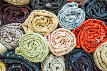 background of colorful fabric stacks