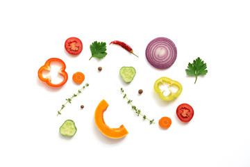 Flat lay pieces of a variety of vegetables on a white background, isolated. Top view