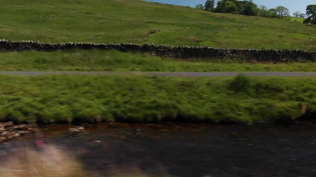 A Dolly style shot (actually shot with a drone) of a country wall and stream. The shot was taken at Barbon Beck Valley, Carnforth. Travelling left to right.