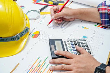 Architect or engineer working project accounting with graph in office, Construction account...