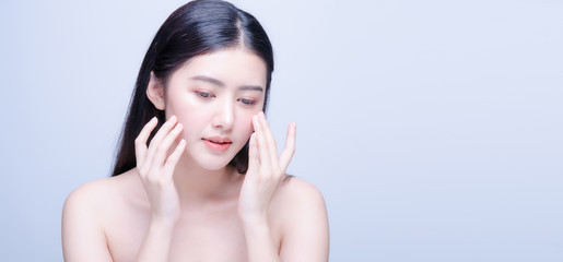 Beauty skin care asian woman smile to you isolated on blue background