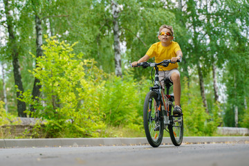 Teenager rides through the park on a bicycle